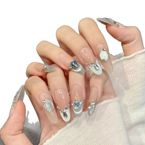 Handmade orange and silver glitter press-on nails in long almond shape with crystals