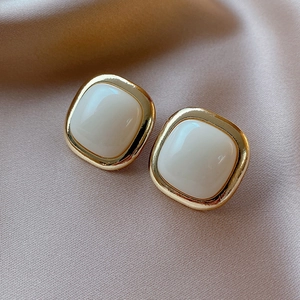 Chic cream acrylic square stud earrings with vintage gold metal frame and silk background
