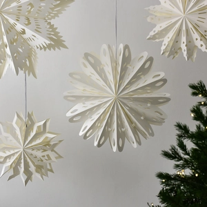 Hanging white paper snowflake ornaments with cutout designs for Christmas tree decorations