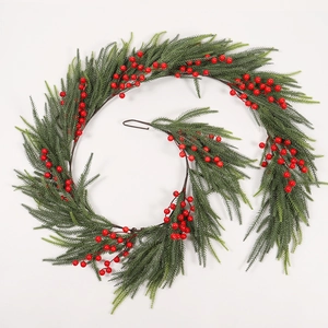 Detailed view of dense red berries and green pine needles on a spiral Christmas garland
