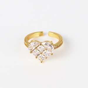 Macro detail of gold-plated open ring featuring a sparkling zircon pavé heart center