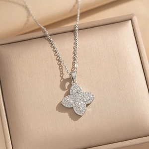 Silver flower clover necklace with sparkling cubic zirconia on a luxury jewelry box