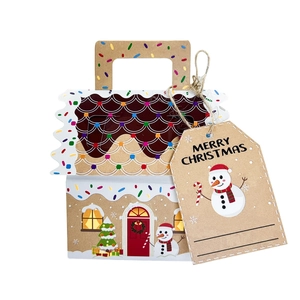 Detail of a Christmas house-shaped kraft paper gift box with a snowman tag and handle