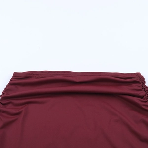 Detailed close-up of wine red ruched fabric with precise double-needle stitching detail