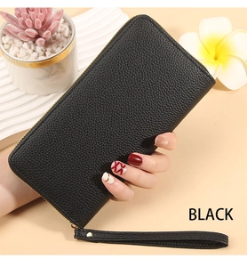 Close-up of black litchi grain leather long wallet with zipper and wrist strap