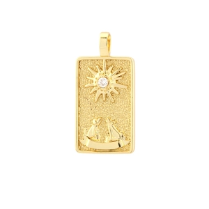 Close-up of golden tarot card pendant with sun pattern and white cubic zirconia stone