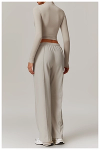 Detailed back view of light gray tight yoga top and high-waisted loose sweatpants set