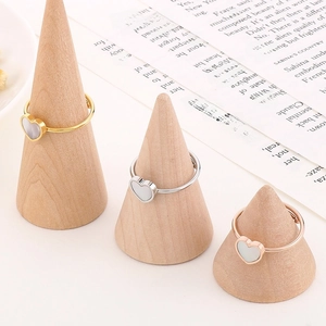 Adjustable heart rings in gold, silver and rose gold finishes on wooden display stands