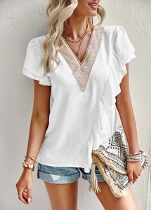 Detail of V-neck short sleeve shirt with delicate lace patchwork and ruffle trim in white