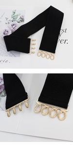 Close-up of black elastic corset belt with a detailed gold metallic interlocking buckle