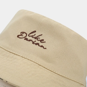 Close-up of Duke Durian embroidery on khaki cotton sun hat showing fabric texture