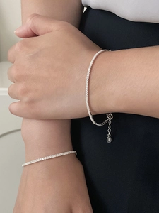 Close-up of S925 sterling silver tennis bracelet with cubic zirconia on a model's wrist
