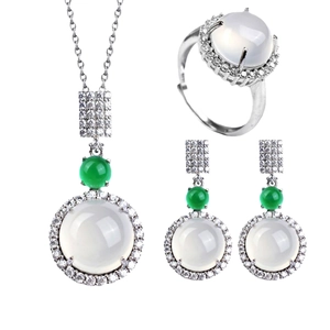 Detailed view of silver jewelry set with white chalcedony and green stone accents