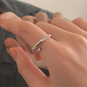 Close-up of 925 sterling silver ring featuring an engraved Smile face on an open band