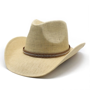 Straw western cowboy hat in light beige with studded brown band and rhinestone accents