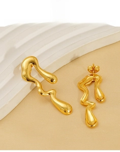 Detail of irregular liquid gold titanium steel stud earrings with shiny metallic finish