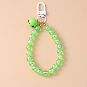 Close-up of green beaded keychain with iridescent beads and a small metal bell
