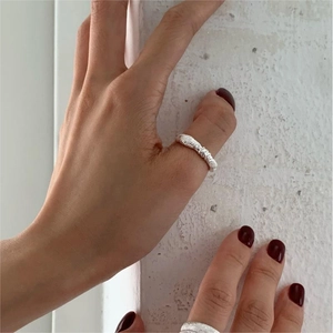 Detailed view of an S925 sterling silver knot ring featuring a spiral textured surface