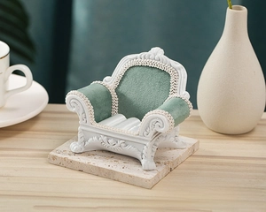 Miniature vintage sofa jewelry display with green velvet and white carved resin frame