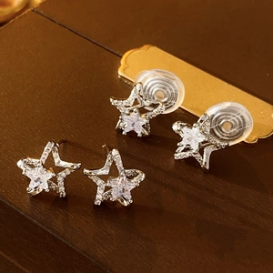 Elegant silver star stud earrings with cubic zirconia inlay on premium leather surface