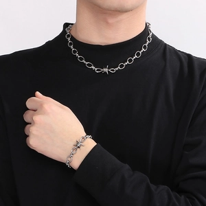 Industrial punk silver thorn knot necklace and bracelet jewelry set on male model