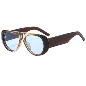 Detail view of retro oversized tea-brown frames and light blue lenses of these aviator sunglasses