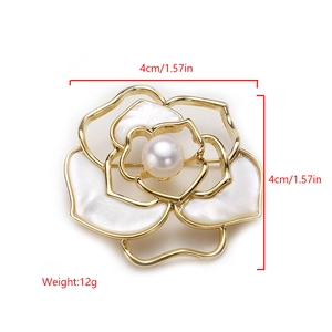 Detailed view of flower brooch with pearl center and shell petals measuring 4cm x 4cm