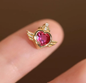 Macro shot of 18K gold plated heart red corundum pendant with wings and crown detail