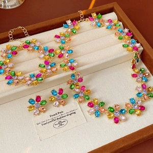 Detailed set of vintage colorful gemstone flower necklace and earrings in jewelry box