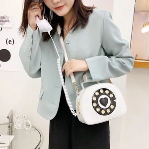 Creative white patent leather crossbody bag in vintage telephone shape with handset detail