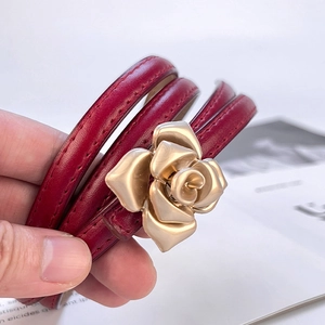 Women's thin red genuine leather belt featuring a 3D gold rose floral metal buckle