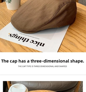 Detail of coffee brown vintage newsboy cap with textured fabric on a wooden table