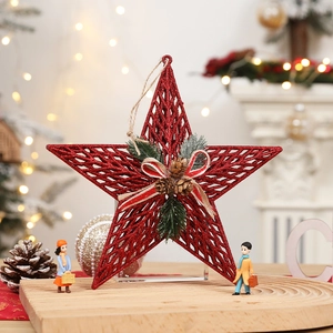 Glittery red metal star tree topper with pine cones and bow for Christmas decor