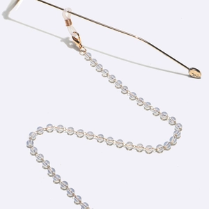 Golden eyewear chain with 5mm opal beads and silicone loops on white background