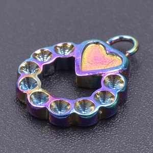 Macro view of a circular stainless steel heart pendant with a rainbow metallic finish