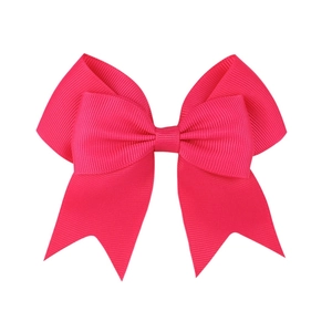 Close-up of rose red grosgrain ribbon hair bow with swallowtail design and textured finish