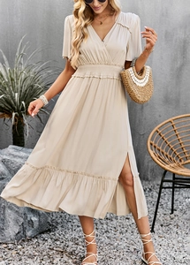Detail of light apricot V-neck dress featuring ruffled sleeves and elegant side slit