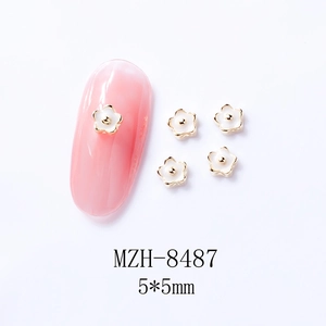 Detailed size view of 5x5mm white alloy flower nail charms with golden edges
