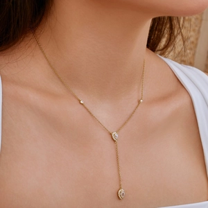 Detailed view of gold S925 silver Y-necklace with teardrop zircon pendants on neck