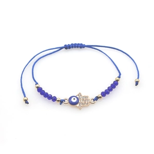 Blue woven Evil Eye and Hamsa hand charm bracelet with gold accents and crystals