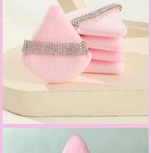 Macro detail of pink triangular powder puffs featuring shimmering rhinestone-studded straps