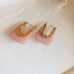 Boucles d'oreilles créoles en résine rose et métal doré sur verre ondulé texturé