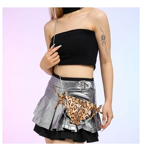 Quirky leopard print bikini shaped crossbody bag with silver chain worn by a model