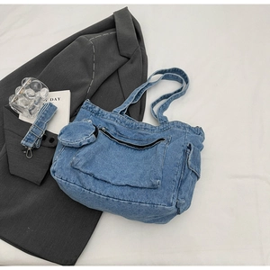 Detail of blue denim tote bag with matching coin purse and adjustable wide strap