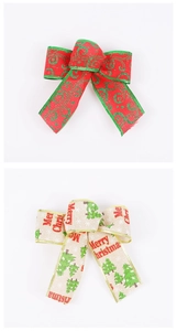 Detail of red glitter swirls and Merry Christmas beige ribbons for tree decoration