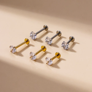 Three pairs of gold and silver internal thread stud earrings with clear round zircons