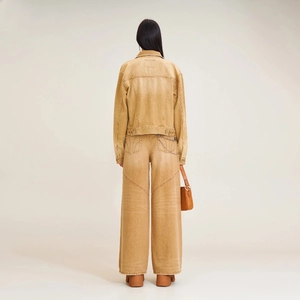 Rear view of distressed ginger denim jacket and high-waisted wide-leg trousers set