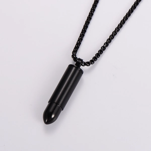 Macro detail of a black stainless steel bullet pendant with matching metal link chain