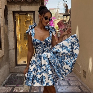 Détail de la robe à fleurs bleues avec bretelles à nœuds élégantes et décolleté en cœur