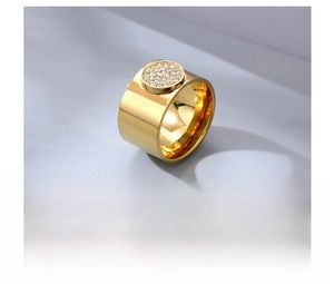 Close-up of a wide gold-plated titanium steel ring featuring pavé-set round cubic zirconia